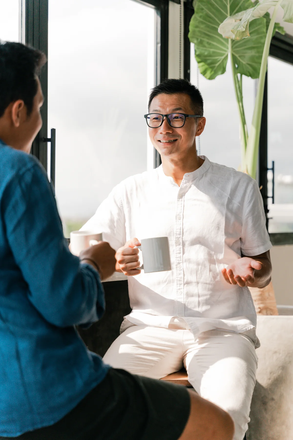 Joe Peng in conversation at a table