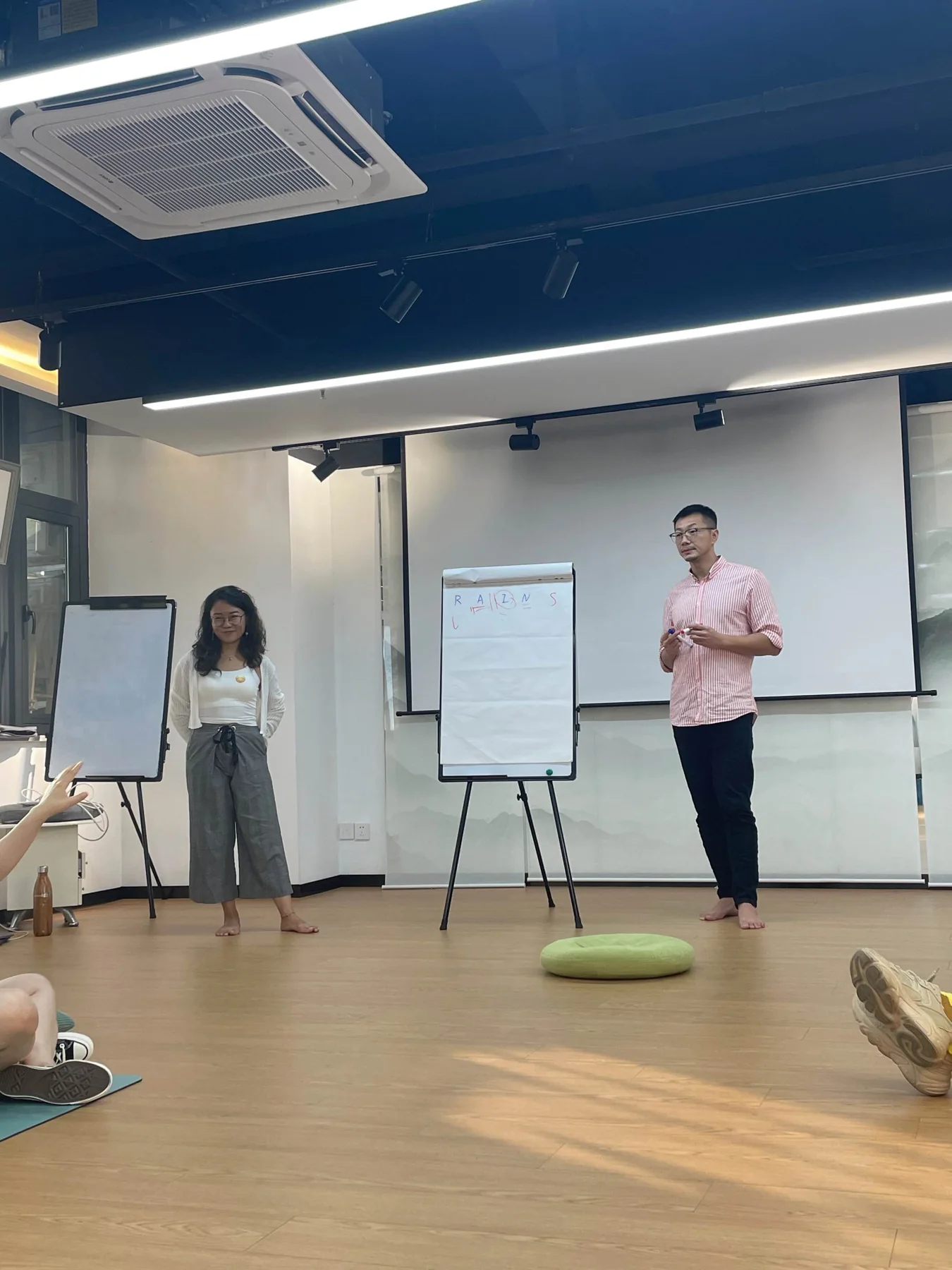 Joe Peng facilitating a group session beside a flip chart